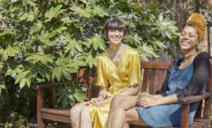Two guardians sitting on a bench laughing.