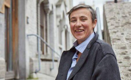 A lady standing outside a property