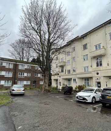 Outside of block of flats in Acton. Grey skies