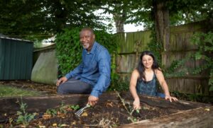 Header image of two guardians volunteering in their garden.