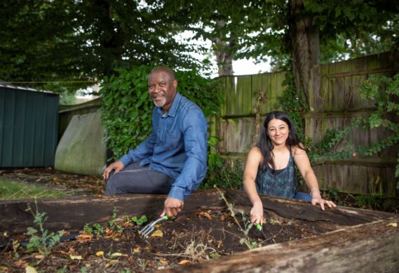 Header image of two guardians volunteering in their garden.